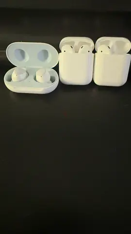 Two pairs of white true wireless earbuds with charging case