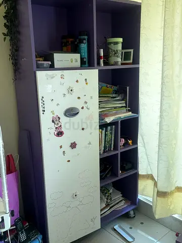 Purple tall storage shelf with cupboard and open cubbies - used