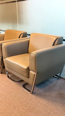 Modern leather armchair with chrome sled base - single piece