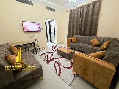 Luxury one-bedroom apartment with a living room and balcony offering an open view. Ajman, Al Rawda 1. Fully furnished, for monthly rent.