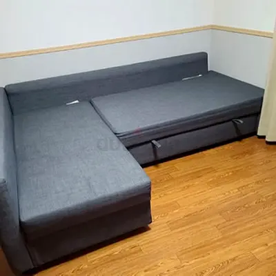 L-shaped grey fabric sofa bed with storage - good condition