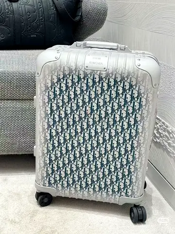 Dior and Rimowa blue carry on suitcase