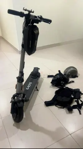 Used electric scooter with helmet and protective gear - good condition