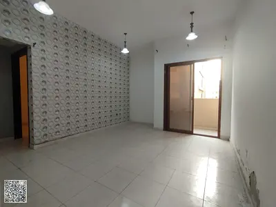 Two-bedroom apartment with a living room and balcony for rent in Al Hamidiya. Central air conditioning and flexible payment options.