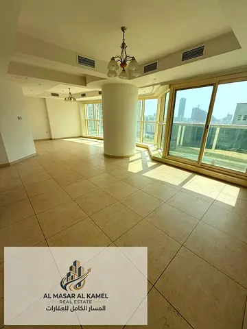 Spacious two-bedroom apartment with a comfortable living room in Al Majaz 3, featuring a practical layout and a prime location close to shops, restaur