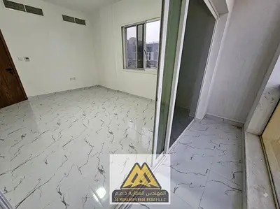 A spacious one-bedroom apartment with a balcony, first occupancy, in the Al-Aliya area, close to all services and Mohammed Bin Zayed Road.