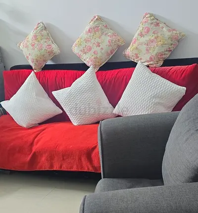 Red fabric sofa bed with cushions - good condition