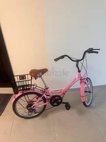 Lightly used pink city bicycle with basket