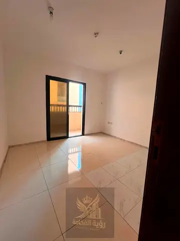 Two-bedroom apartment with living room for annual rent in Al Majaz 2, strictly for bachelors. Featuring 2 bathrooms and a balcony. Annual rent AED 38,