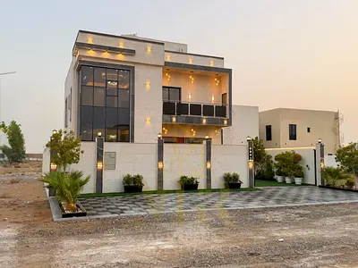 Luxury villa for sale in Al Amrah area – Ajman | Two floors and a roof terrace, 6 master bedrooms with a swimming pool | Includes air conditioning, el