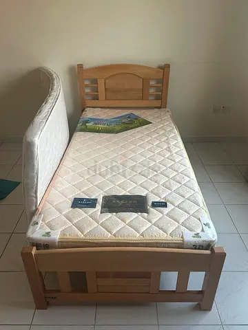 Single wooden bed frame with mattress