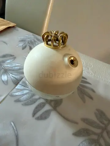 Pair of cream curtain finials with decorative crown tips