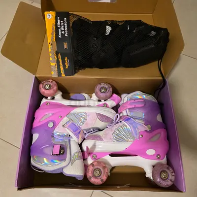 Kids adjustable pink quad roller skates with protective gear - like new