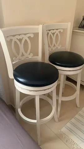 Pair of white wooden bar stools with black round seats