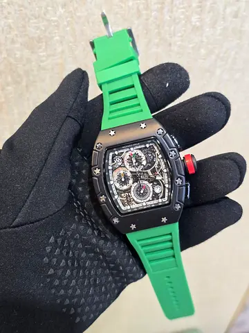Black tonneau chronograph watch with green rubber strap