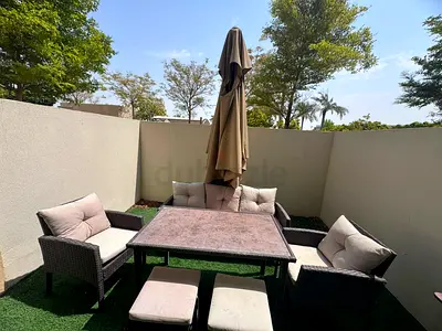 Outdoor rattan patio dining set with cushions and umbrella