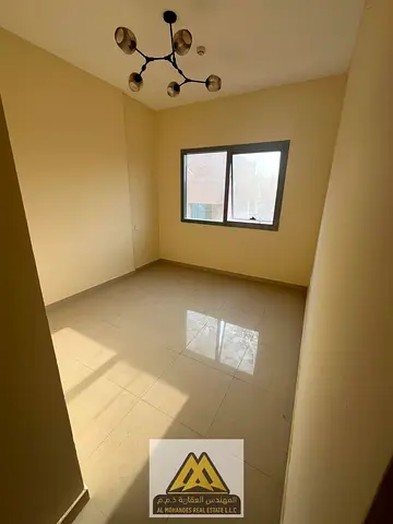Two bedrooms and a living room with a balcony offering an open view in Al Nuaimiya Tower One, close to all services and main roads.