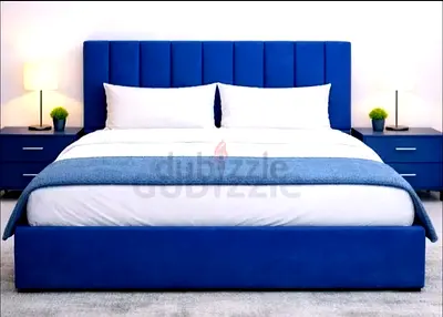 Blue upholstered king size bed with padded headboard