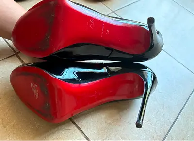 Used black patent leather high heels with red soles (size unknown) - preowned