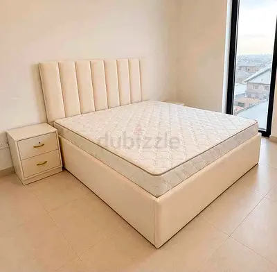 New Beige upholstered Queen Size bed with mattress and bedside table