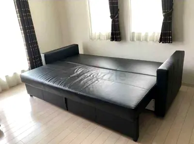 Black faux leather sofa bed, converts to large bed - good condition