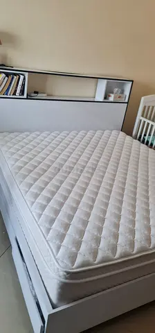 White wooden king size bed frame with mattress and headboard shelf - Excellent condition