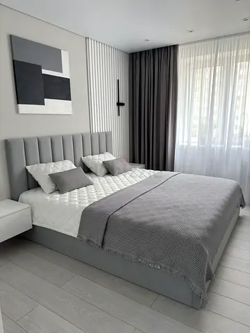 Modern grey upholstered double bed with headboard