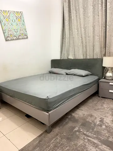 Grey queen bed frame with upholstered headboard 2 side tables, dresser, lamp and mattress included