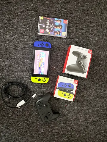 Nintendo Switch console with Joy-Con, Pro Controller and FIFA game - Good condition