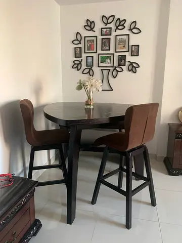 Solid heavy Dark wood high dining table with upholstered chairs and bench .