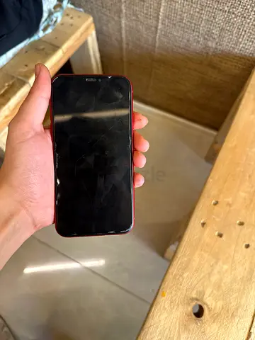 iPhone (red) with cracked screen - usable, needs screen repair