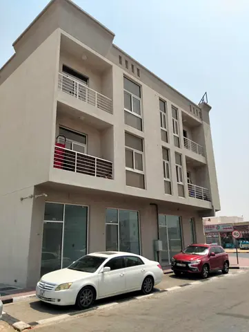 Mixed-Use Building for Sale in Al Zahya Ajman for AED 4M, 8 Apartments, 6 Shops, Main Road & Projected Income of AED 370K