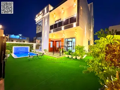 Luxury villa for sale in Al Amrah area – Ajman | Two floors and a roof terrace, 6 master bedrooms with a swimming pool | Includes air conditioning, el