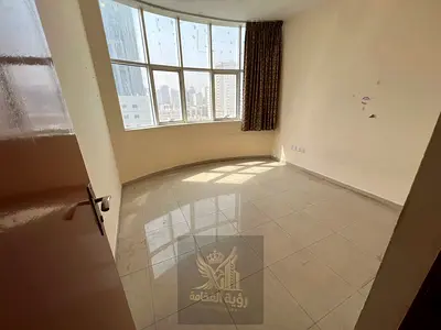 Two-bedroom apartment with living room for annual rent in Al Qasimia, Sharjah, near Mega Mall, featuring 2 bathrooms and parking included. Annual rent