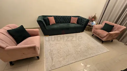 Modern sofa set with dark green 3 seater and two pink armchairs