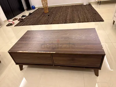 Used low-profile wooden coffee table with drawers — brown