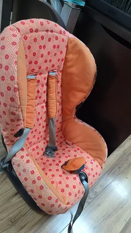 Used infant car seat with removable orange patterned cover