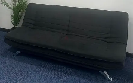 Black fabric futon sofa bed — convertible, good condition. Double size.