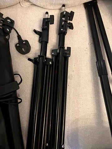 Pair of adjustable light stands / tripods with carry bag and UK plug. Rarely used.