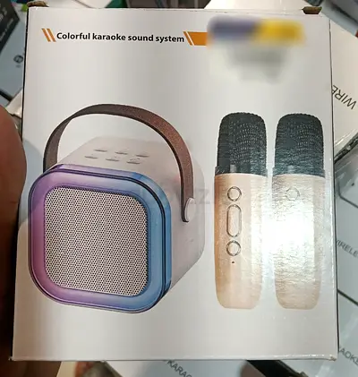 Portable karaoke speaker with two wireless mics - compact colorful sound system.