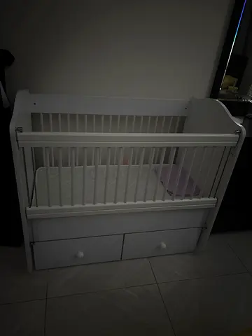 White wooden baby crib with storage drawers - good condition