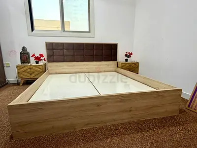 Queen-size wooden platform bed with padded headboard — good condition