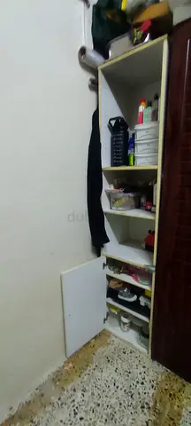 A white and beige multi-shelf tall storage