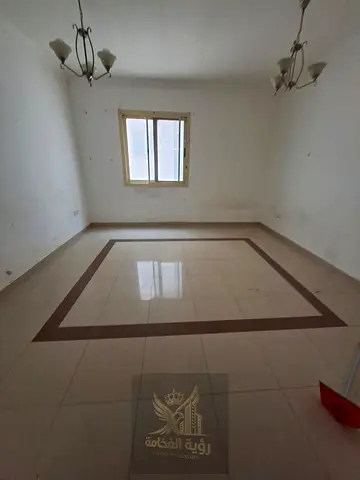 For rent in Abu Shagara Sharjah spacious one bedroom and living room with central AC and two bathrooms annual rent 33000 AED payment in 4 or 6 install