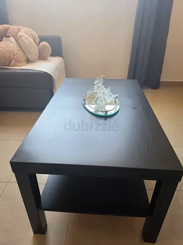 Simple black rectangular coffee table with lower shelf