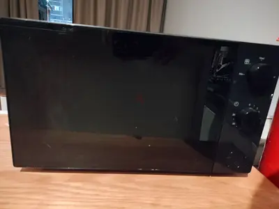 Used countertop microwave oven with mechanical dials — good working condition