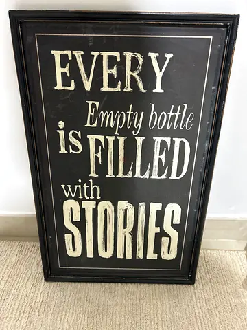 Framed Rustic Wall Sign — "Every Empty Bottle Is Filled With Stories"