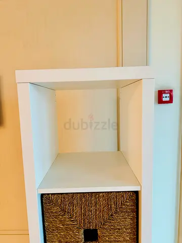 Slim white 4-tier shelving unit with 2 wicker drawers