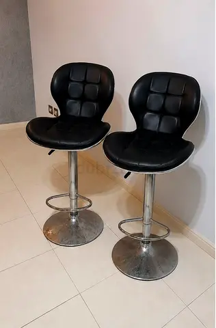 Pair of black adjustable bar stools with chrome base — good condition