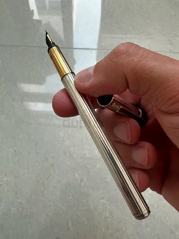 Cartier Silver striped metal fountain pen with gold trim